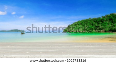 Wooden table top with blurred of beautiful beach nature background use for products display