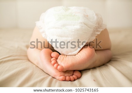 small child is sleeping in a diaper
 Royalty-Free Stock Photo #1025743165