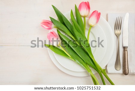Valentines day table setting with pink tulips on white wooden background. Top view, space for text