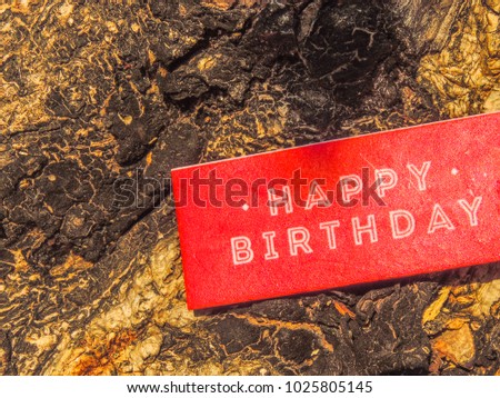 Red Label Or Tag On Bark Wood Tree texture background With English Text Happy Birthday Vintage Retro Or Rustic Style