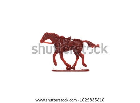 Red plastic miniature toy horse with saddle isolated on white background Royalty-Free Stock Photo #1025835610