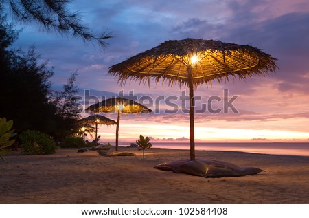 Sunset and umbrella on beach Phang Nga, Thailand