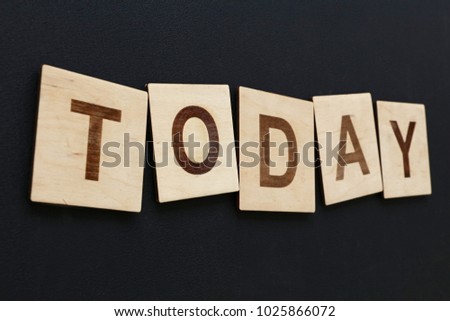 Close up word TODAY on wooden scrabble letter signs over black board background