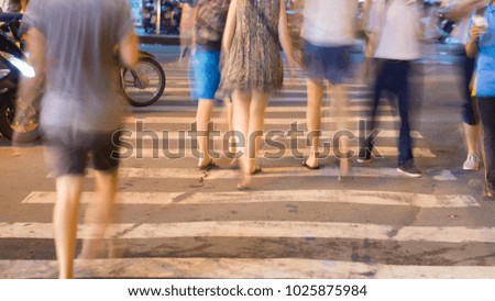 Blurred motion of cars and people on the pedestrian pedestrian passage. Vietnam. Saigon city.
