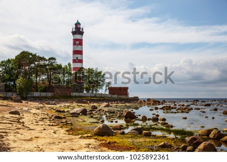 Red and white lighthouse, Russia . Photographed during the day in cloudy weather Royalty-Free Stock Photo #1025892361