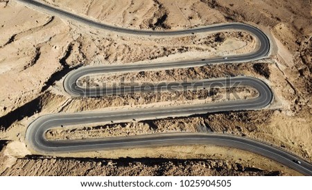 Desert road - Aerial image of traffic going up and down a  serpentine mountain road