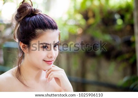 Pretty young attractive asian woman relaxing at cafe blurred nature background.