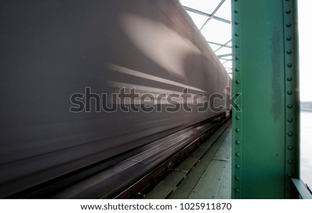 Close up picture of freight train in motion on bridge