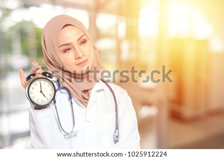 Medical staff and clock with orange sunlight background