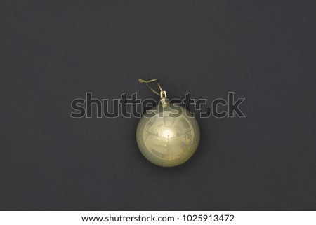 Yellow Christmas Bauble Tied Over Black Background