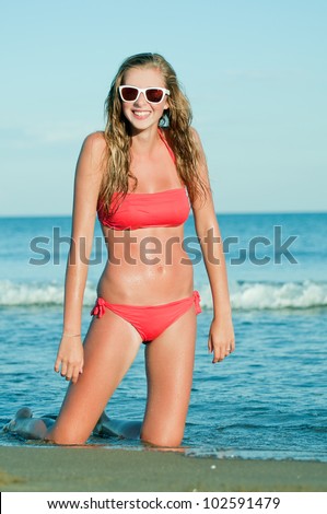 Summer beach - Beautiful young girl in bikini at the beach