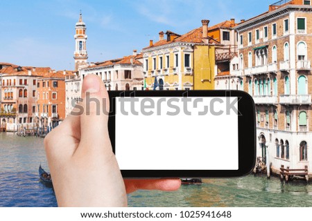 travel concept - tourist photograps palaces on Grand Canal in Venice city in Italy in spring on tablet with cut out screen for advertising logo