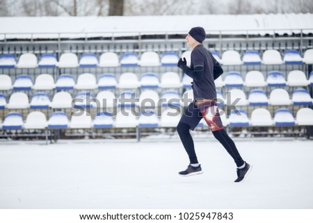 Photo of running athlete in stadium