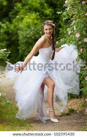Beautiful brunette bride portrait in summer park