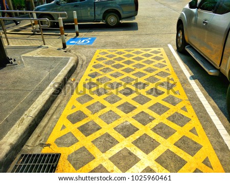 The signs of no parking in this channel and channel for wheelchair on the ground in parking area 