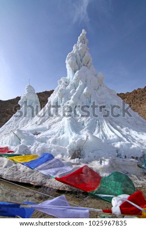 Ice stupa with mountain background in winter Leh Ladakh, India.