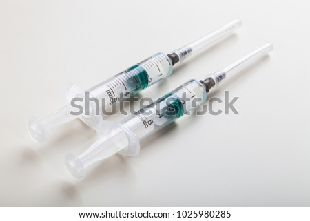 Syringes on white table, prepared for injection in hospital labaratory Royalty-Free Stock Photo #1025980285