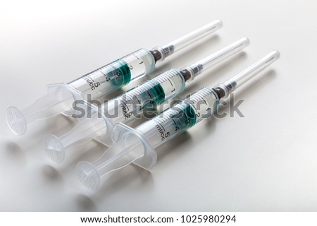 Syringes on white table, prepared for injection in hospital laboratory Royalty-Free Stock Photo #1025980294