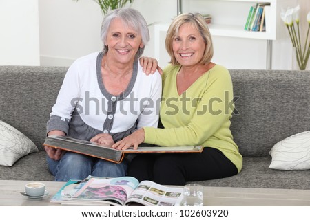 Mother and daughter looking at a picture album together