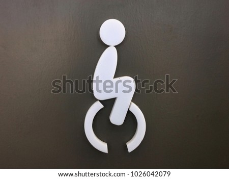 Handicap or wheelchair symbol, Disabled toilet sign, white WC sign isolated on brown background.