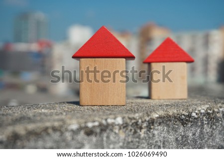 Real estate concept, Choose your best deal, buying one of this houses ,House searching concept ,Little wooden house made of toy blocks on beautiful blue sky with clouds                               