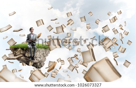 Funny man in red glasses and suit sitting on floating island and reading book