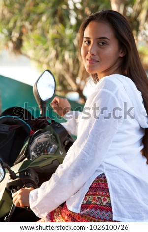 beautiful young woman with motorbike