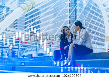 Business woman serious a falling down graph of stock.