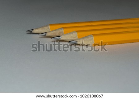 Four pencils arranged in a row