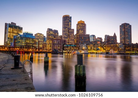 The architecture of the Boston Harbor and Financial District in Boston, Massachusetts, USA at sunset.