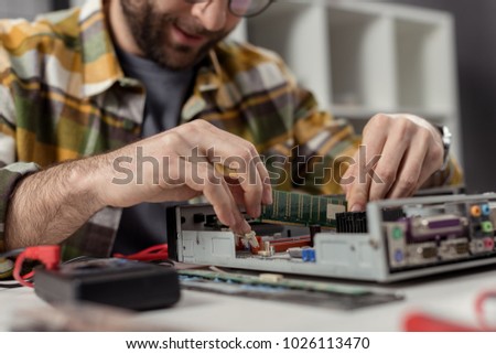 caucasian man reapairing repairing computer
