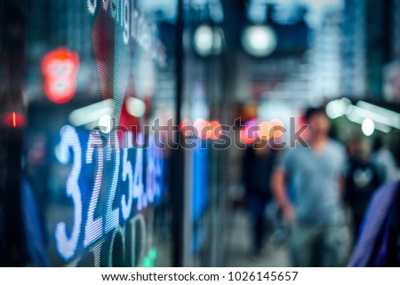 Display of Stock market quotes with city scene reflect on glass