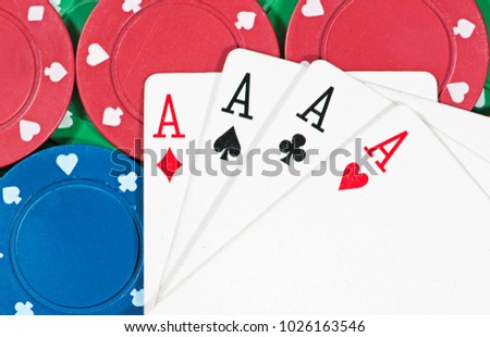 Poker Chips and Playing Cards - both related to gambl