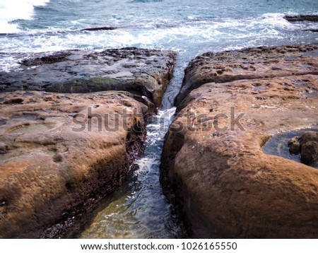 The sea eroded rocks, making the rocks separate.