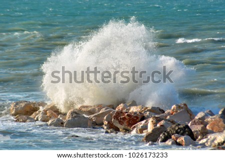 Waves break on the rocks of the Adriatic Sea in the Mediterranean southern Italy