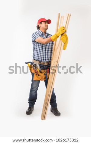 Handsome Indian Carpenter or wood worker in action, isolated over white background