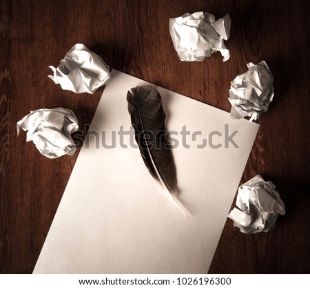 still life of paper and a crumpled paper on a table with a pen on a wooden table