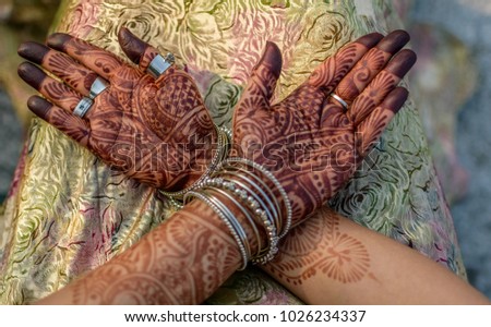 Mehendi hands of a Indian woman with selective focus.