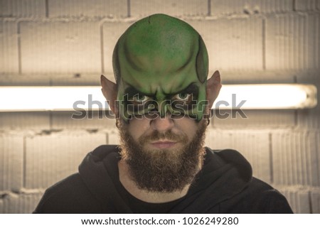 Leprechaun Make Up. Portrait of a leprechaun with a beard. Portrait of a man. Green Make up