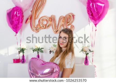 Cute dark-skinned girl with long hair photographed with beads in the shape of a heart