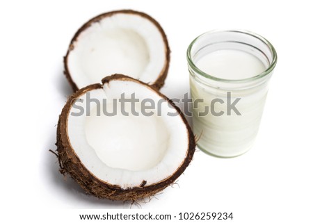 Broken coconut isolated on a white background with coconut milk