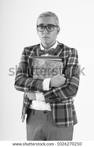 sad nerd man standing in checkered jacket and glasses with notebooks on white background
