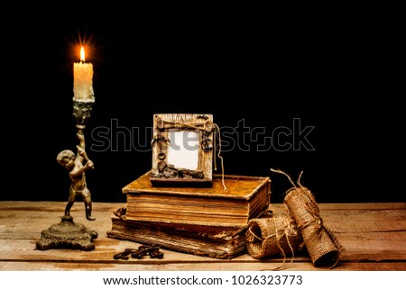 old still life picture frame , books and candlestick