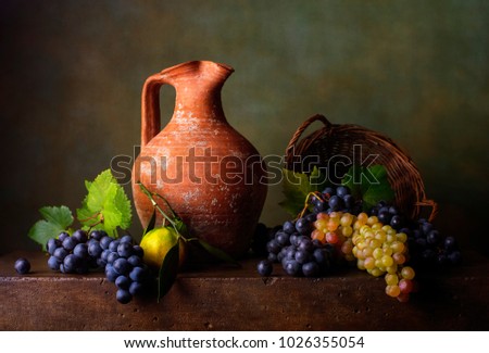 Still life with grapes in the basket and jug