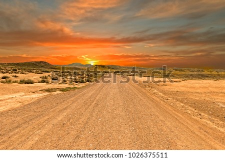 Highway through the desert on a sunset, Spain Royalty-Free Stock Photo #1026375511