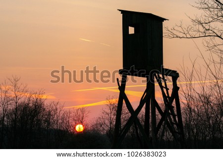 Hunting stand during beautiful sunset, useful for hunting magazines, articles, news