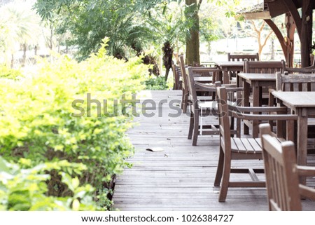 Wood chair and table in the restaurant on nature background with copy space.