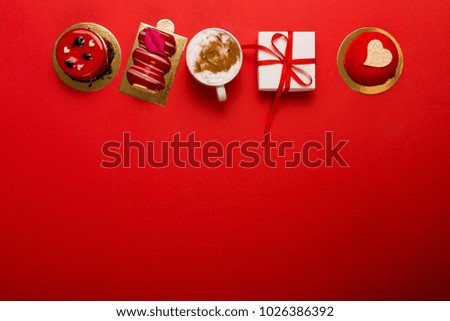 Present and deserts on a bright red background with a copy space
