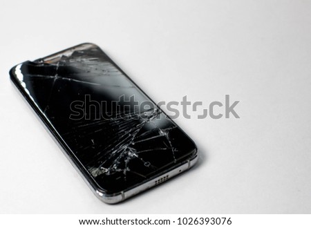 Close up of broken screen smart phone isolated on white background