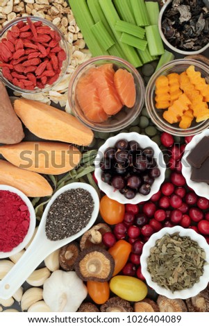 Health food concept for better brain power with fish, fruit, vegetables, seeds and herbs, super foods high in minerals, vitamins, antioxidants, anthocyanins, fibre and omega 3 fatty acids, top view.